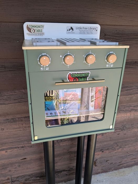 Small, Green, Toy Stove filled with free books. Little Free Library, charter #190304